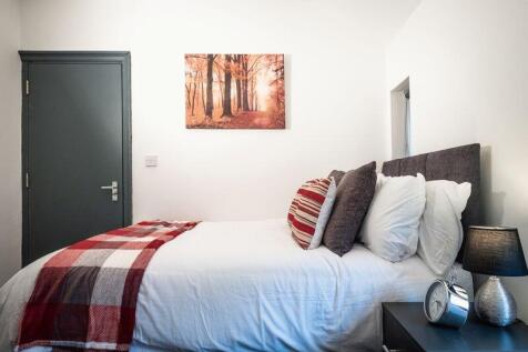 Bright and cozy double bedroom featuring a comf...