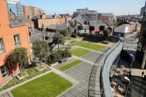 A well-maintained garden area surrounded by mod...