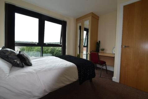 A bright, cozy double bedroom featuring a comfo...