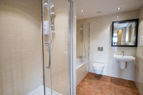 A modern and well-maintained bathroom suite fea...