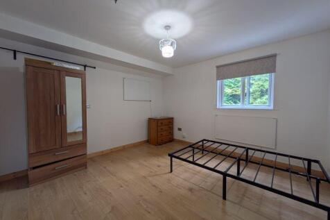 A bright and tidy double bedroom featuring a wo...
