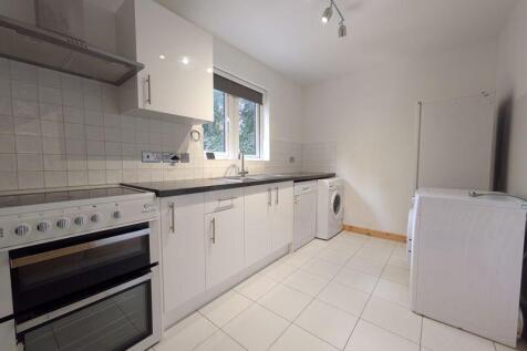 Bright and modern kitchen featuring sleek white...