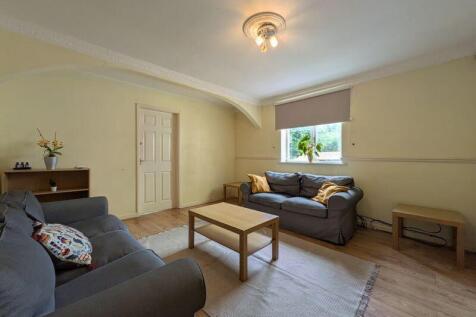 A cozy living room featuring comfortable sofas,...