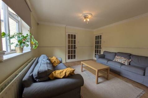 A cozy and well-maintained living room featurin...