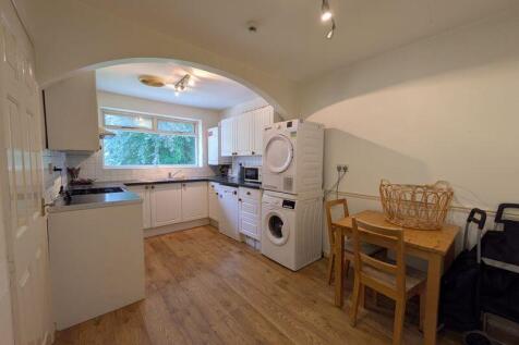 Bright and tidy kitchen featuring modern applia...
