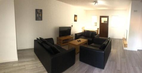 A modern living room featuring a neat and spaci...