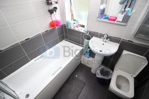 Bright and modern bathroom featuring a full-siz...