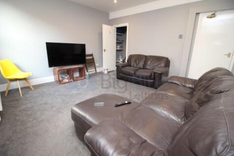 A comfortable living room featuring plush brown...