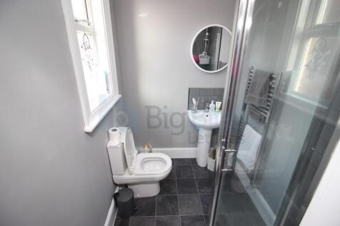 A clean and modern bathroom featuring a glass-e...