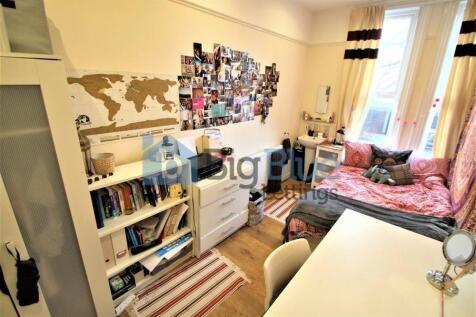 Bright and cozy single bedroom featuring a comf...