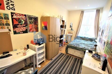 A cozy and well-organized single bedroom featur...