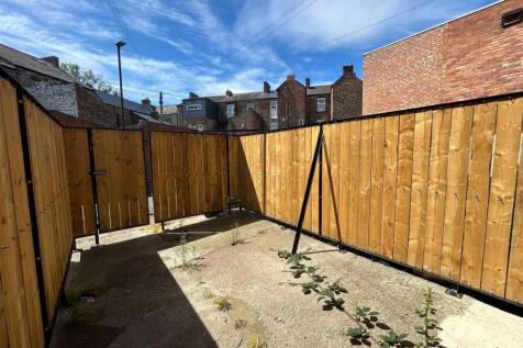 Bright and private garden space with tall woode...