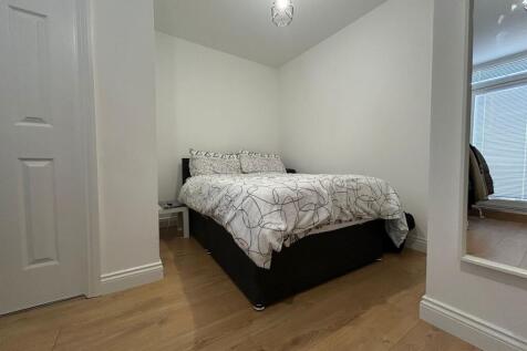A cozy double bedroom featuring a neatly made b...