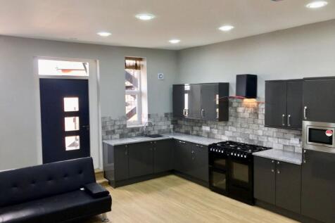 Modern kitchen with sleek dark cabinets, a larg...