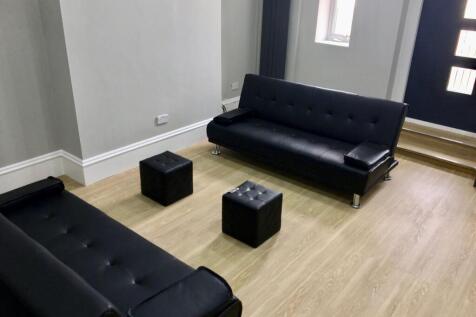 A modern communal lounge featuring sleek black ...