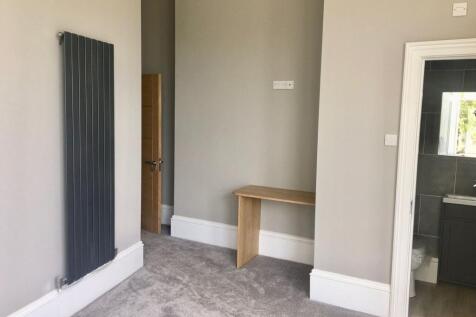 A clean and modern hallway featuring neutral to...