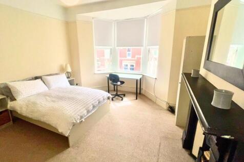 Bright and spacious master bedroom featuring a ...