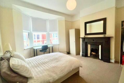 A bright and spacious master bedroom featuring ...