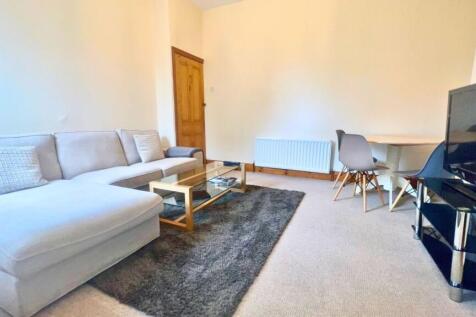 A contemporary living room featuring a spacious...