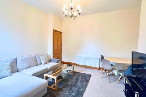 A bright and welcoming living room featuring a ...