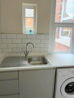 Bright and clean kitchen area featuring a moder...