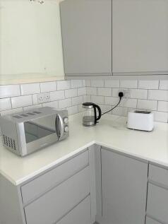 A modern and tidy kitchen corner featuring slee...