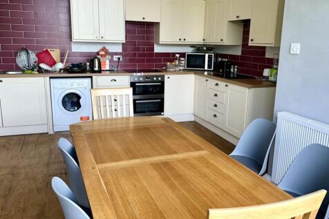 Bright and spacious kitchen area featuring a la...