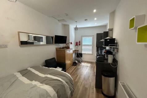 A cozy and neat single bedroom featuring a comf...