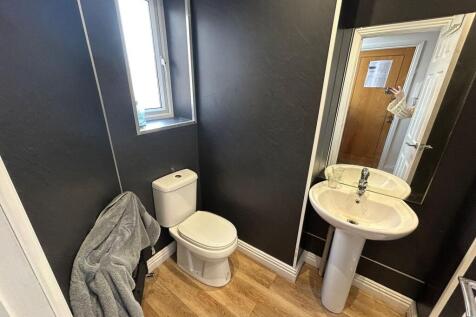 A modern bathroom suite featuring a clean white...