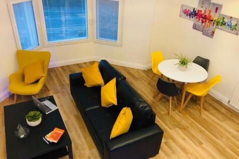A bright and inviting living room featuring a c...