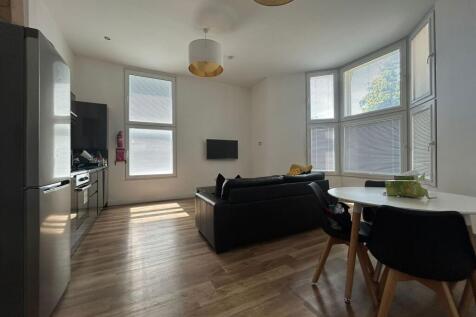 Bright and modern living room featuring a spaci...