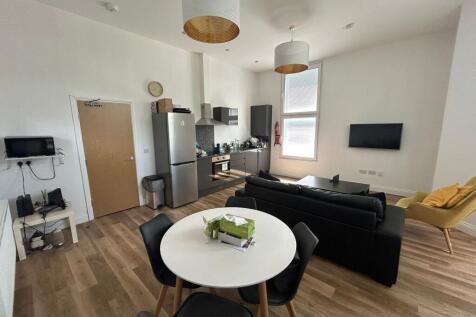 Bright and modern living space featuring a slee...