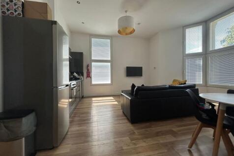 Bright and modern living room featuring large w...