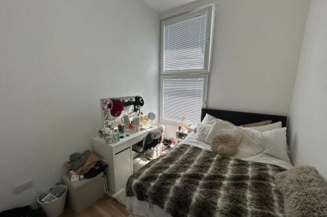Cozy double bedroom featuring a plush double be...