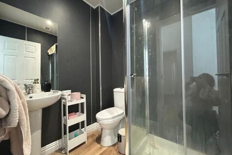 Modern bathroom featuring a spacious shower enc...