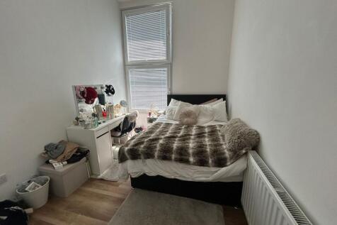A cozy and well-kept single bedroom featuring a...
