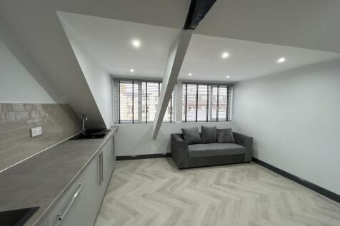 Modern kitchen area with sleek cabinetry, ample...