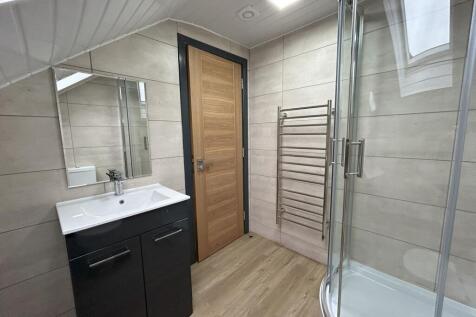 Modern bathroom suite featuring a spacious curv...