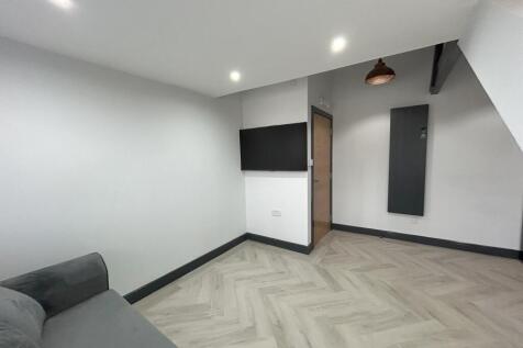 A modern living room featuring a clean, neutral...