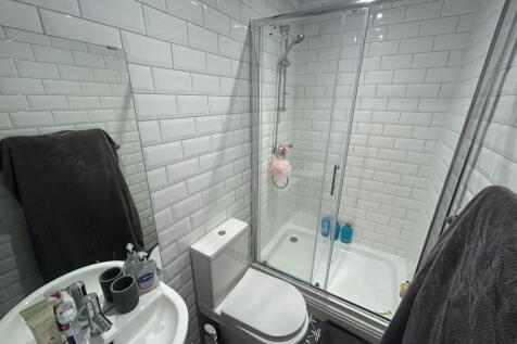 A bright and modern bathroom suite featuring a ...