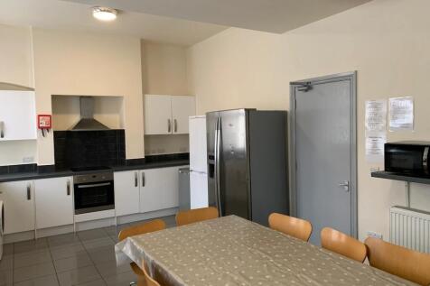 Bright and tidy communal kitchen featuring mode...