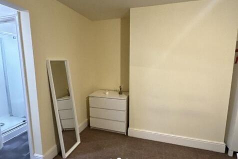 A simple and clean single bedroom featuring neu...