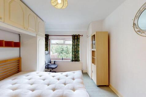 Bright and airy master bedroom featuring a comf...