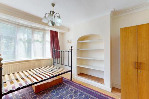 A bright and cozy bedroom featuring a large win...