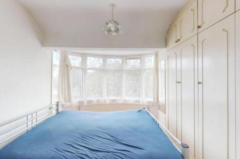 Bright and airy master bedroom featuring a larg...