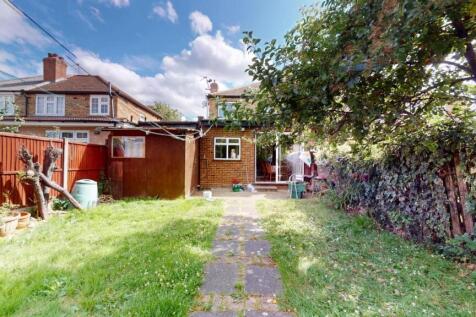 A spacious and well-maintained garden with lush...