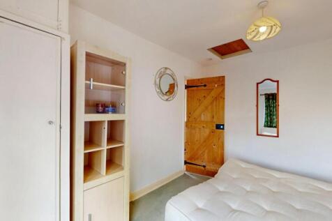 Bright and cozy master bedroom featuring a larg...