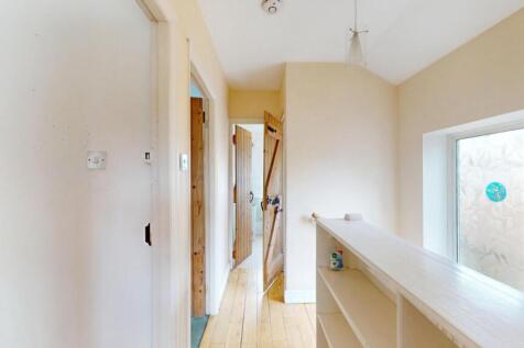 Bright and clean hallway with natural light str...