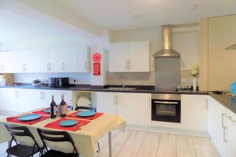 Bright and modern kitchen featuring ample white...