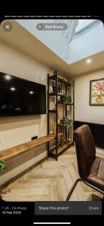 A modern communal lounge featuring a sleek wall...